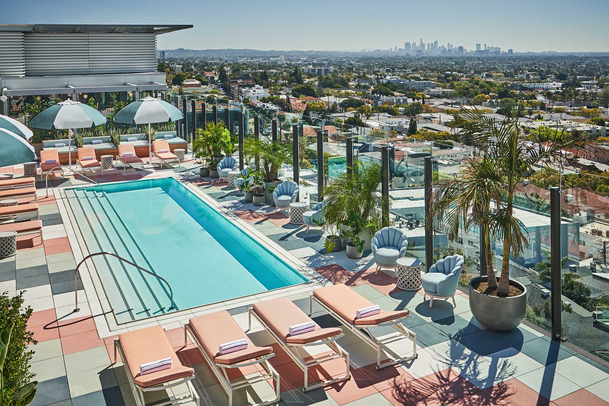 The rooftop pool at the Pendry West Hollywood is pictured from above, with the Los Angeles skyline seen in the distance. West Hollywood, California.