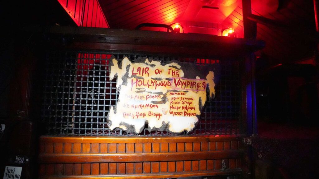 A sign at the Rainbow Bar & Grill says "Lair of the Hollywood Vampires," with a list of names including Alice Cooper, Keith Moon, John Linen, Ringo Starr, Harry Nilsson and Mickey Dolenz. West Hollywood, California. 