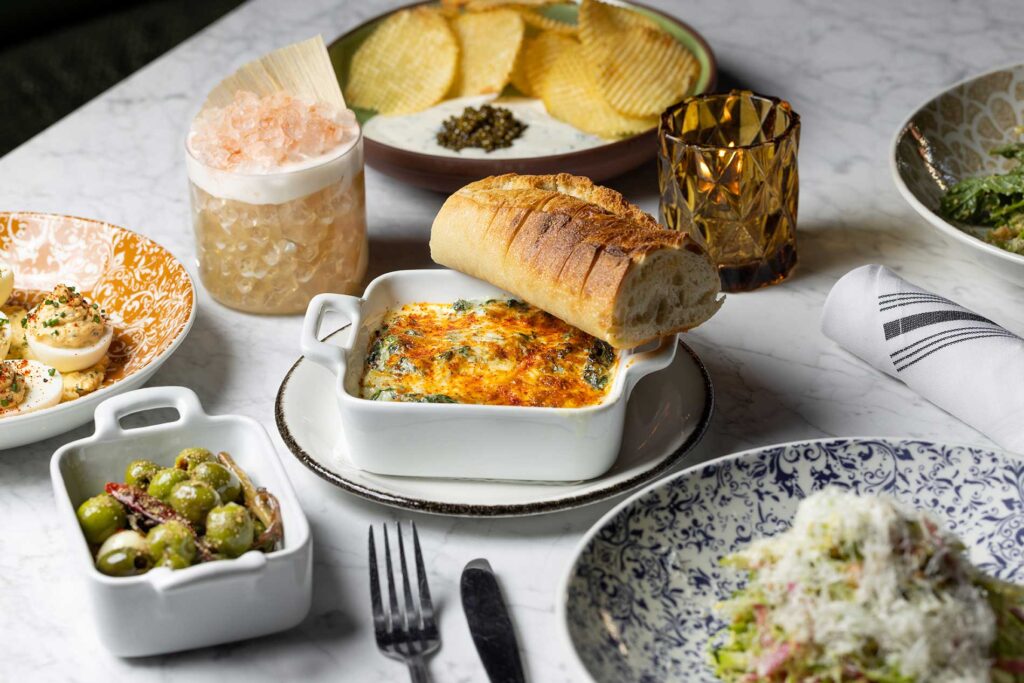 Overhead shot of a table filled with food at Den on Sunset. West Hollywood, California.